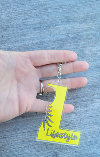 Lifestyle Keychain / Zipper Pull with the letter L, Lifestyle, and an outline of an upside down pineapple, Alternative Lifestyle Keychain