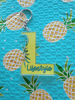 Lifestyle Keychain / Zipper Pull with the letter L, Lifestyle, and an outline of an upside down pineapple, Alternative Lifestyle Keychain
