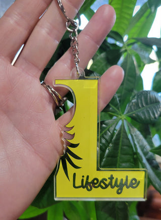 Lifestyle Keychain / Zipper Pull with the letter L, Lifestyle, and an outline of an upside down pineapple, Alternative Lifestyle Keychain